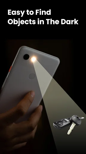 Flashlight app illuminating lost keys on dark surface, demonstrating practical object detection in darkness